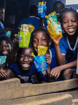 Happy children holding candies with joyful smiles